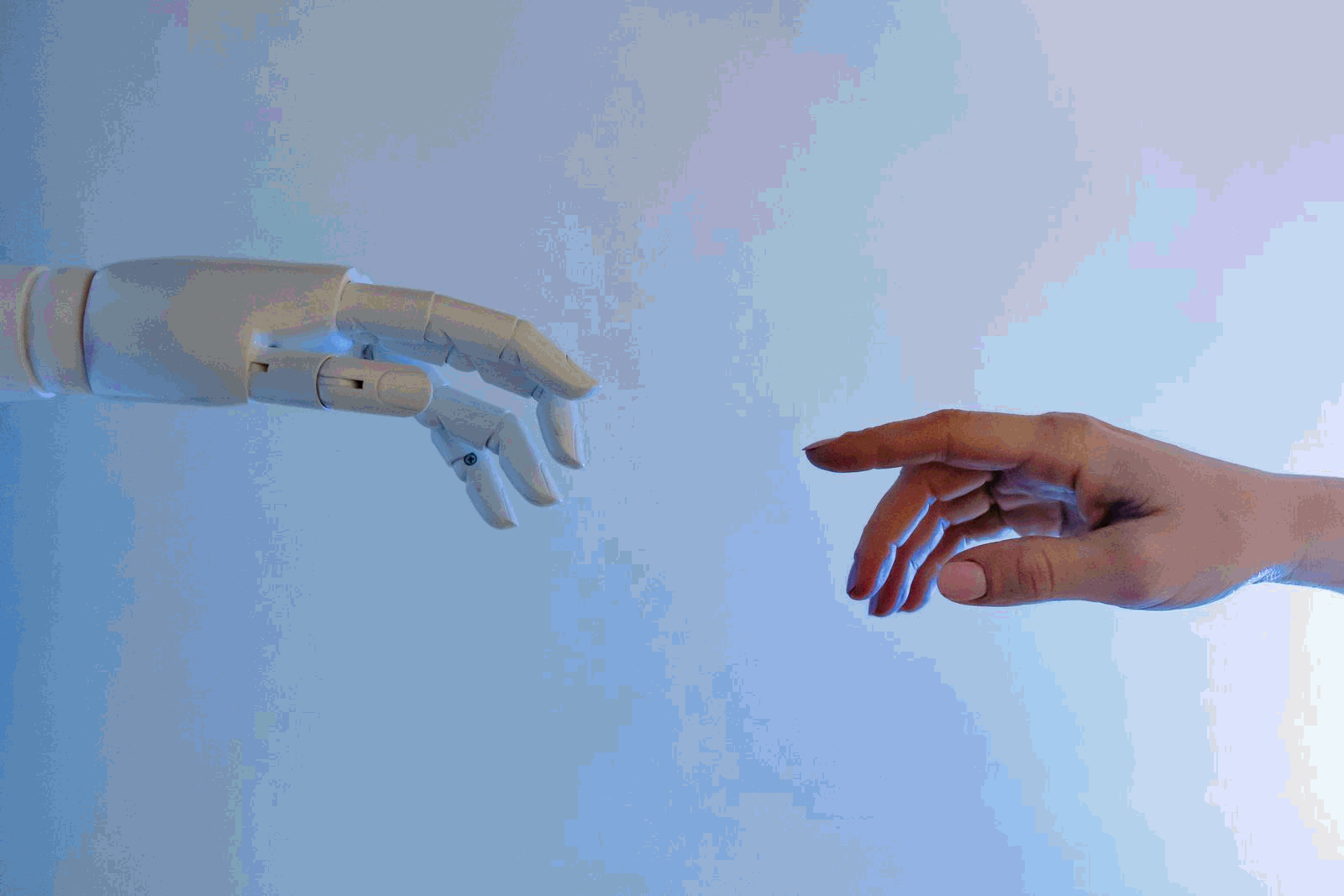 Person reaching out to a robot representing human-AI collaboration and agentic workflows