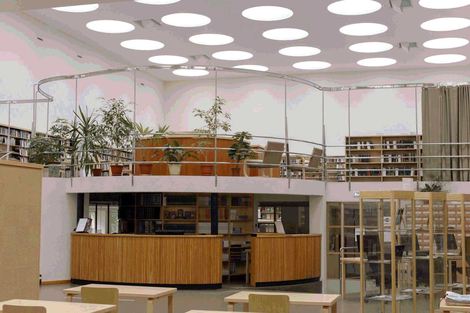 Spacious modern library interior with organized bookshelves and study desks