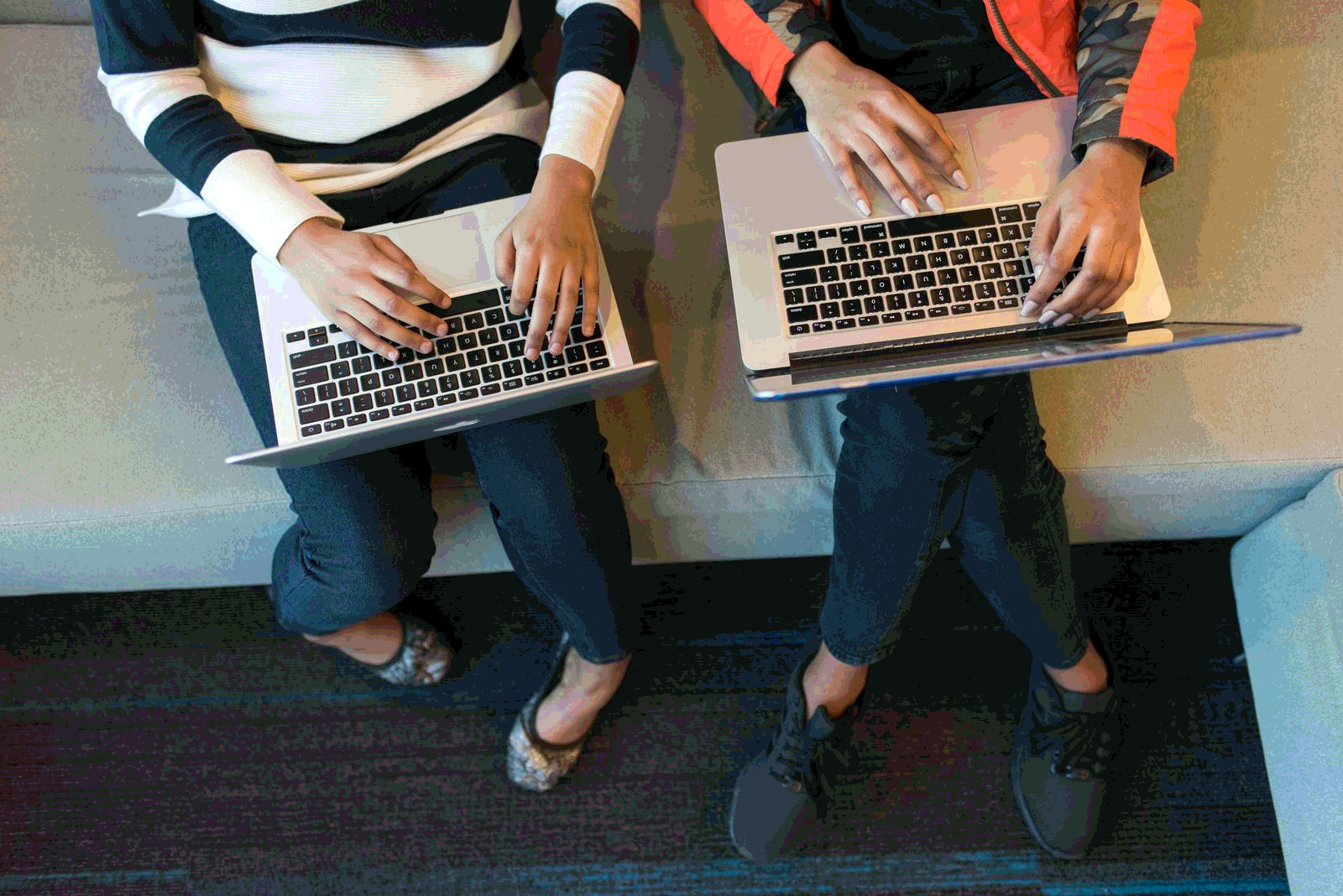 Two marketers working on laptops for an email campaign