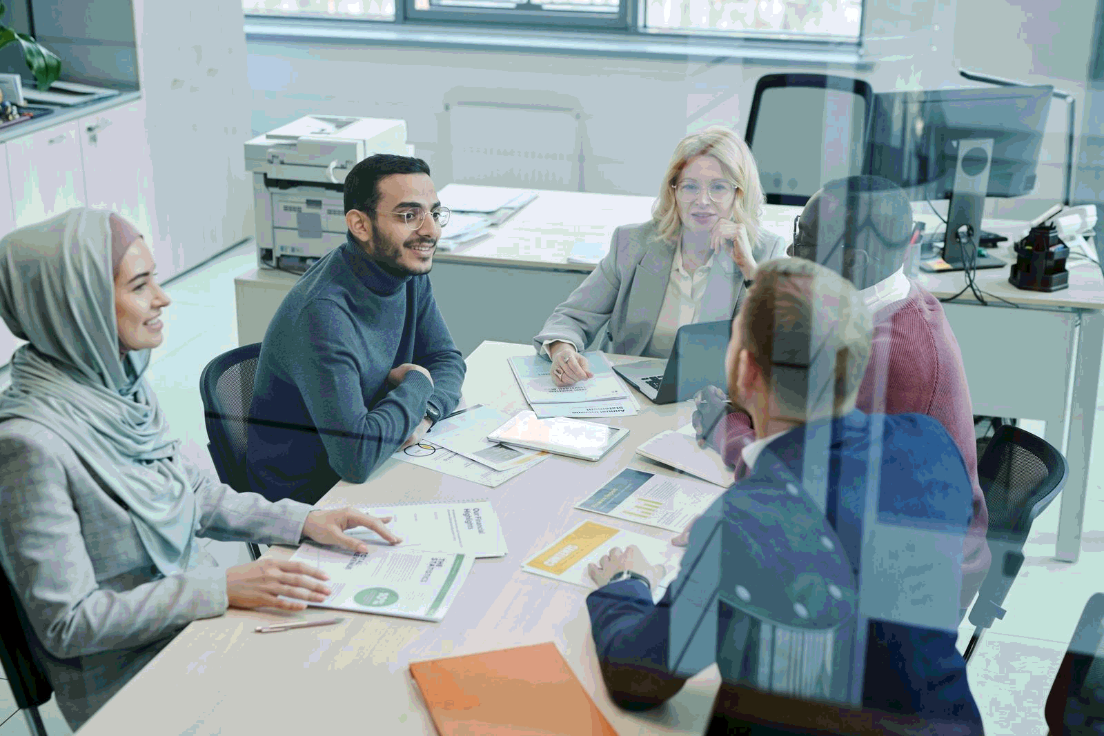 Diverse group of professionals collaborating in a modern office meeting