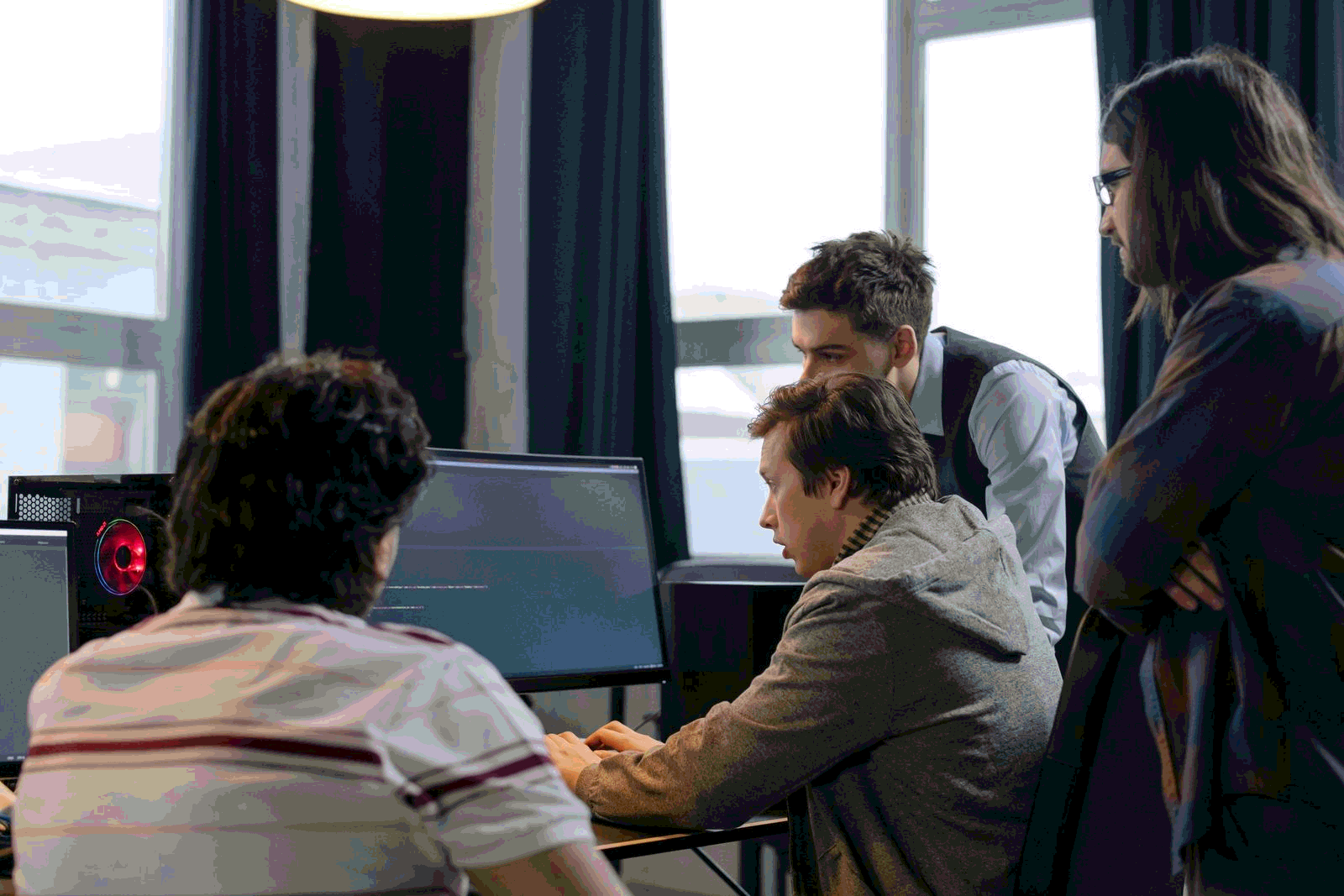 Developers collaborating on a programming project with AI coding assistance